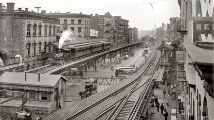 Black and white HD desktop wallpaper featuring a vintage steam train traveling on elevated tracks through an urban setting with surrounding buildings and pedestrians.
