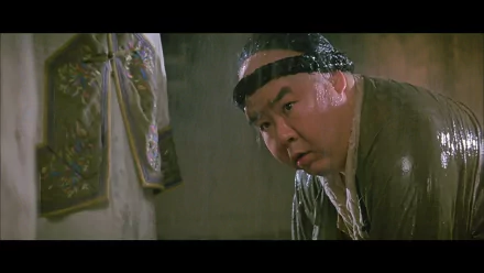 HD PC desktop wallpaper from the movie Once Upon a Time in China: a soaked, headband-wearing man leans forward in a dim, ornate interior.