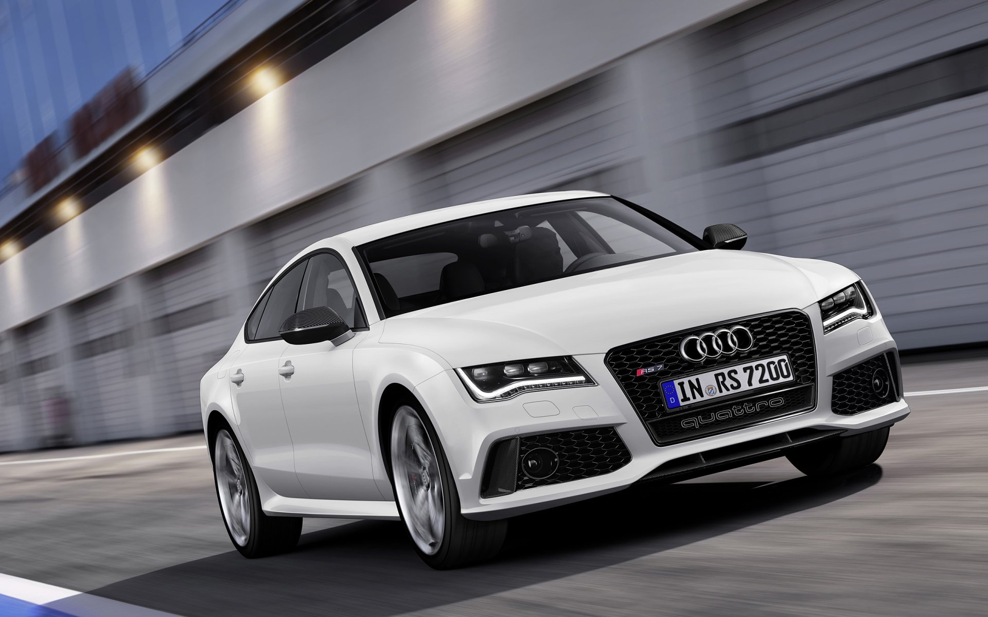 White Audi RS7 in motion with blurred background, shown as a 2K Quad HD PC desktop wallpaper of the Audi vehicle.