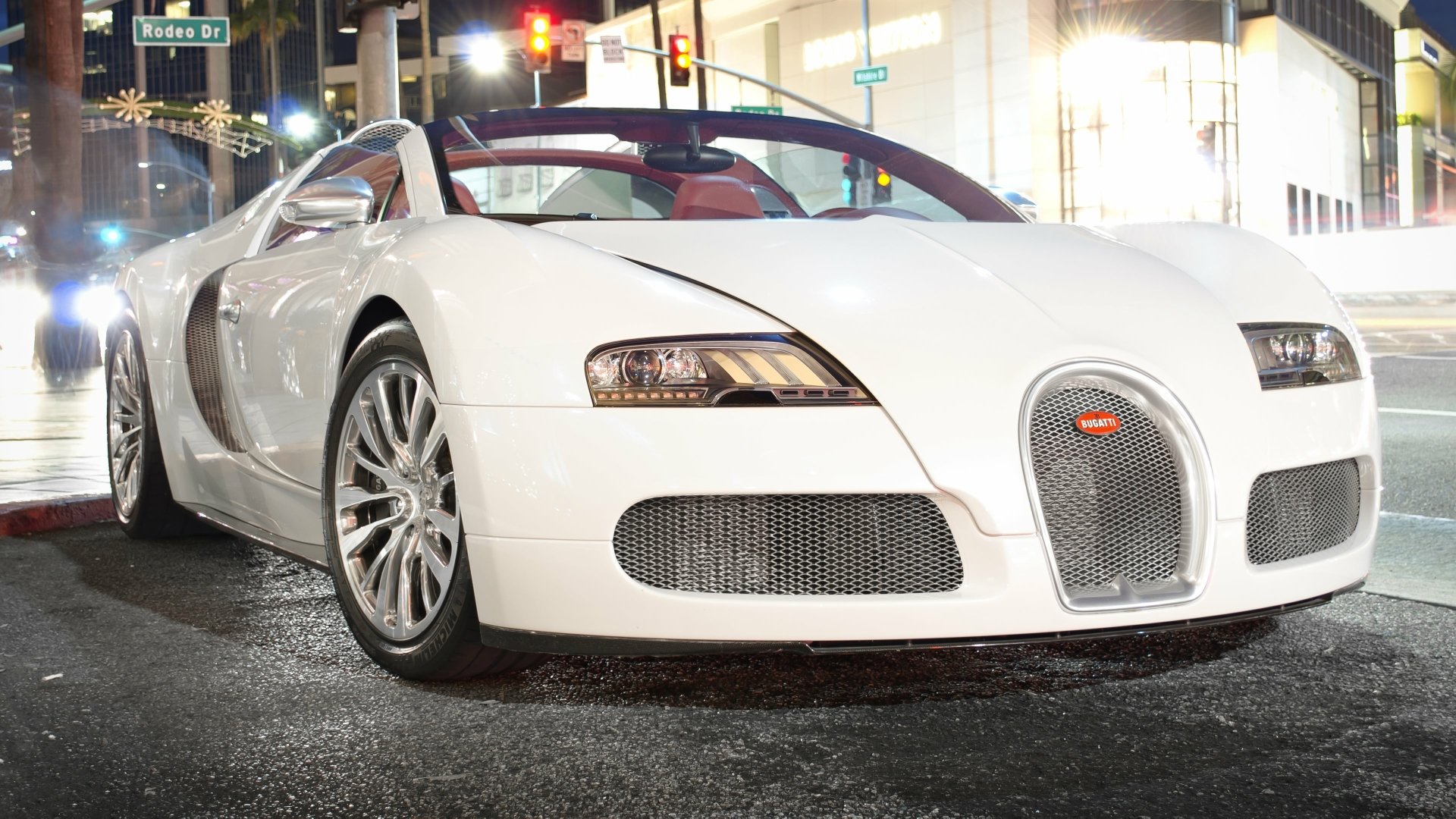 White Bugatti Veyron parked on a city street at night, captured in 4K Ultra HD for a PC desktop wallpaper and background.