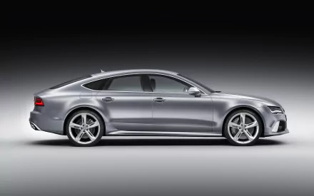 HD desktop wallpaper featuring a sleek silver Audi RS7, showcasing its dynamic design and sporty elegance against a dark gradient background.