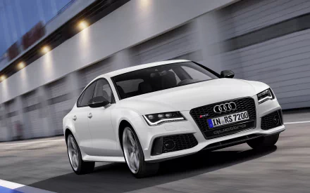 White Audi RS7 in motion with blurred background, shown as a 2K Quad HD PC desktop wallpaper of the Audi vehicle.