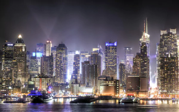 Nighttime HD desktop wallpaper showcasing the illuminated Manhattan skyline, highlighting iconic man-made structures across New York and New Jersey waterfronts.