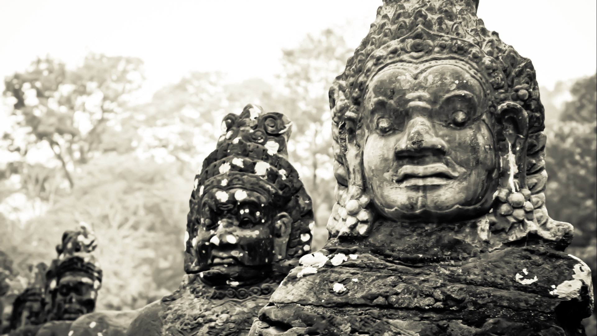 Close-up of ancient religious stone statues at Angkor Thom, captured in high-definition for a PC desktop wallpaper background.