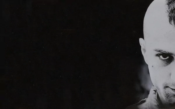 Black and white HD wallpaper featuring Robert De Niro in a dramatic close-up from the movie Taxi Driver, capturing his intense gaze against a dark background.