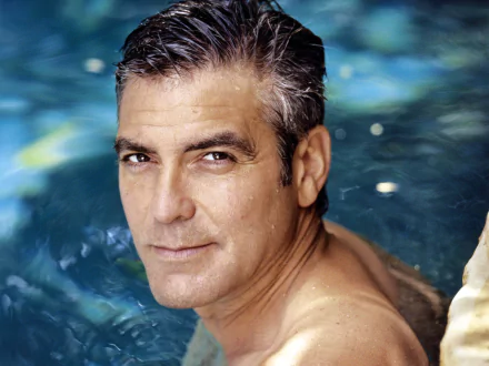 HD PC desktop wallpaper: close-up portrait of a middle-aged man with wet salt-and-pepper hair in a blue pool, calm expression and soft lighting.