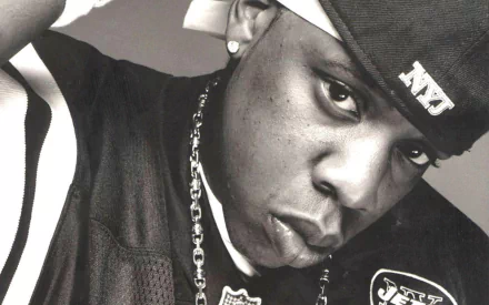 Black and white HD desktop wallpaper featuring a close-up of Jay-Z wearing a cap and chain, capturing the essence of the singer and music icon.