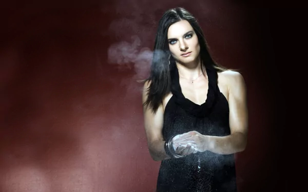 HD PC desktop wallpaper featuring Yelena Isinbayeva in a black outfit, surrounded by a smoky, dramatic sports-themed background.