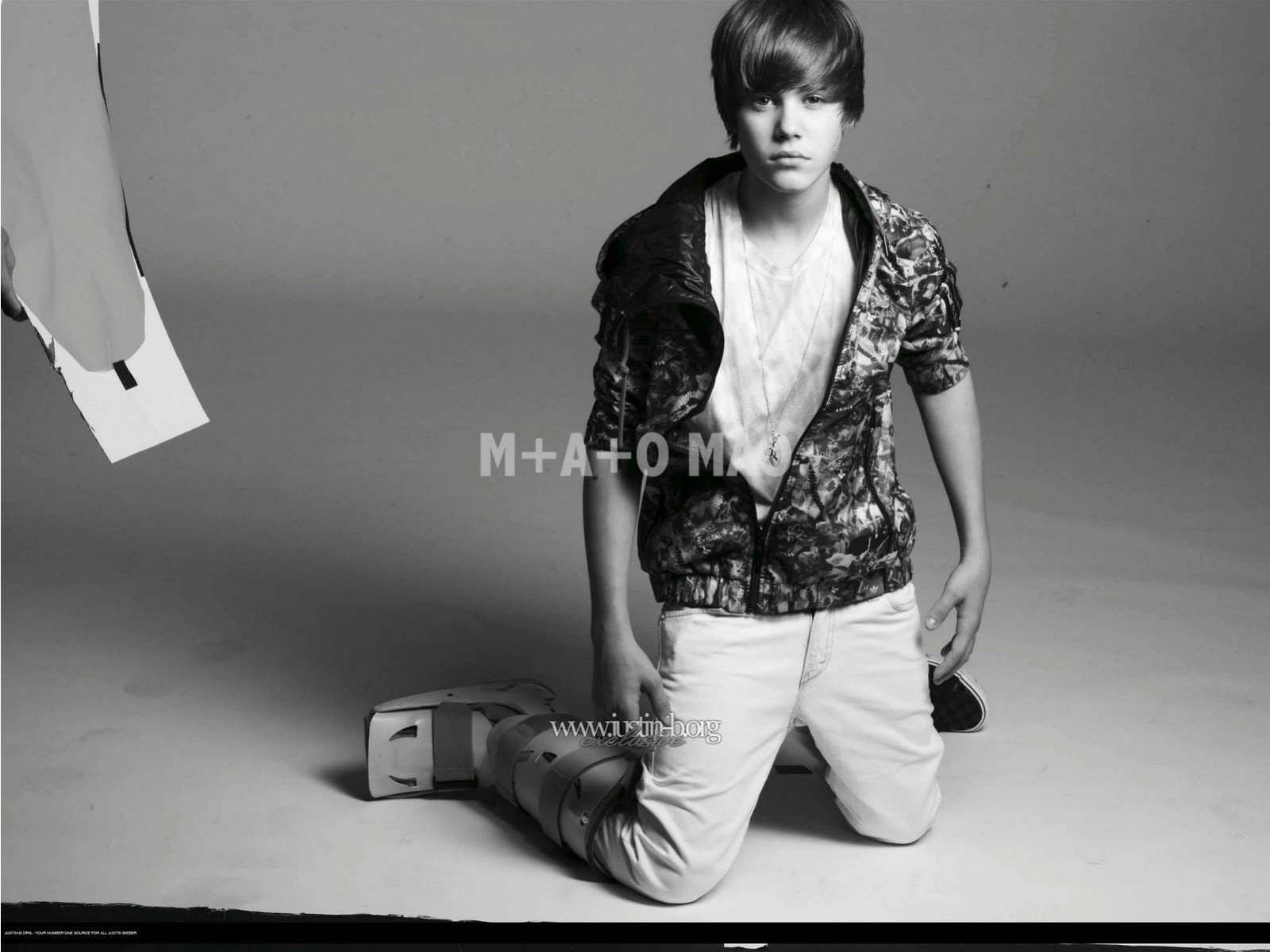 HD desktop wallpaper featuring a monochrome photo of a young male celebrity posing for a stylish shoot.