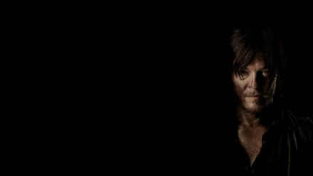 A dramatic HD wallpaper from *The Walking Dead*, featuring a close-up of a rugged character against a dark background, evoking a sense of tension and survival.