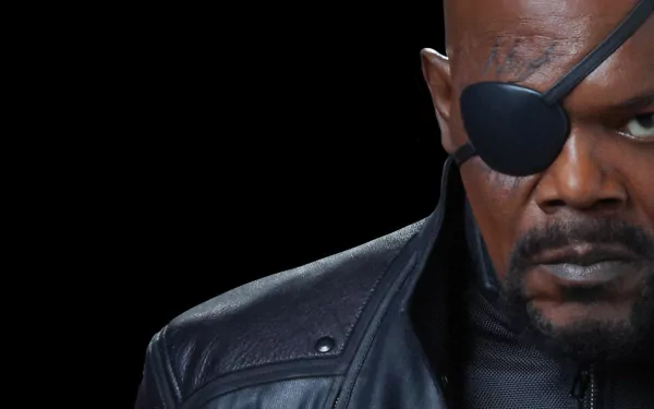 HD wallpaper of a Nick Fury character from The Avengers, featuring an intense close-up on a dark background.
