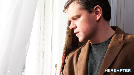 HD desktop wallpaper featuring Matt Damon from the movie Hereafter, looking contemplative by a window.