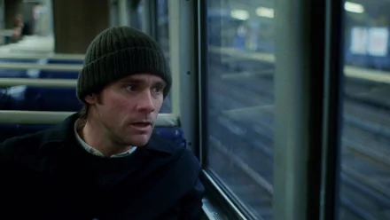 Jim Carrey in Eternal Sunshine of the Spotless Mind as an HD desktop wallpaper, depicting a thoughtful scene on a train.