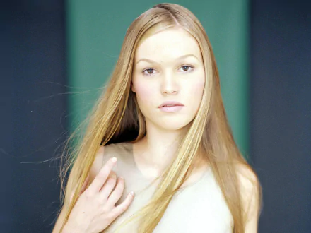 A stunning HD desktop wallpaper featuring Julia Stiles, showcasing her natural beauty with long, flowing hair and a serene expression against a softly colored background.