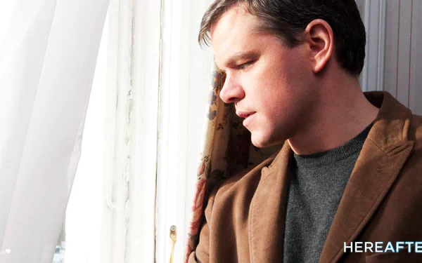 HD desktop wallpaper featuring Matt Damon from the movie Hereafter, looking contemplative by a window.