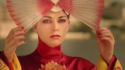 HD desktop wallpaper of Justine Waddell as Nurse Evelyn from the movie The Fall, featuring vibrant traditional attire and a decorative fan against a blurred background.
