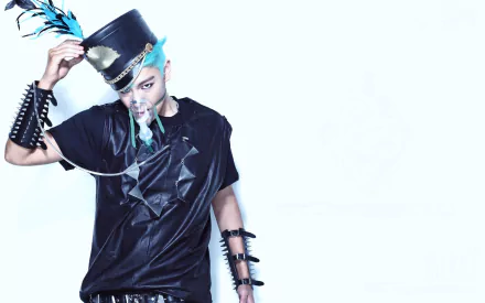 HD wallpaper featuring T.O.P, the rapper from Bigbang, showcasing his unique style with a feathered top hat and striking accessories against a light backdrop.