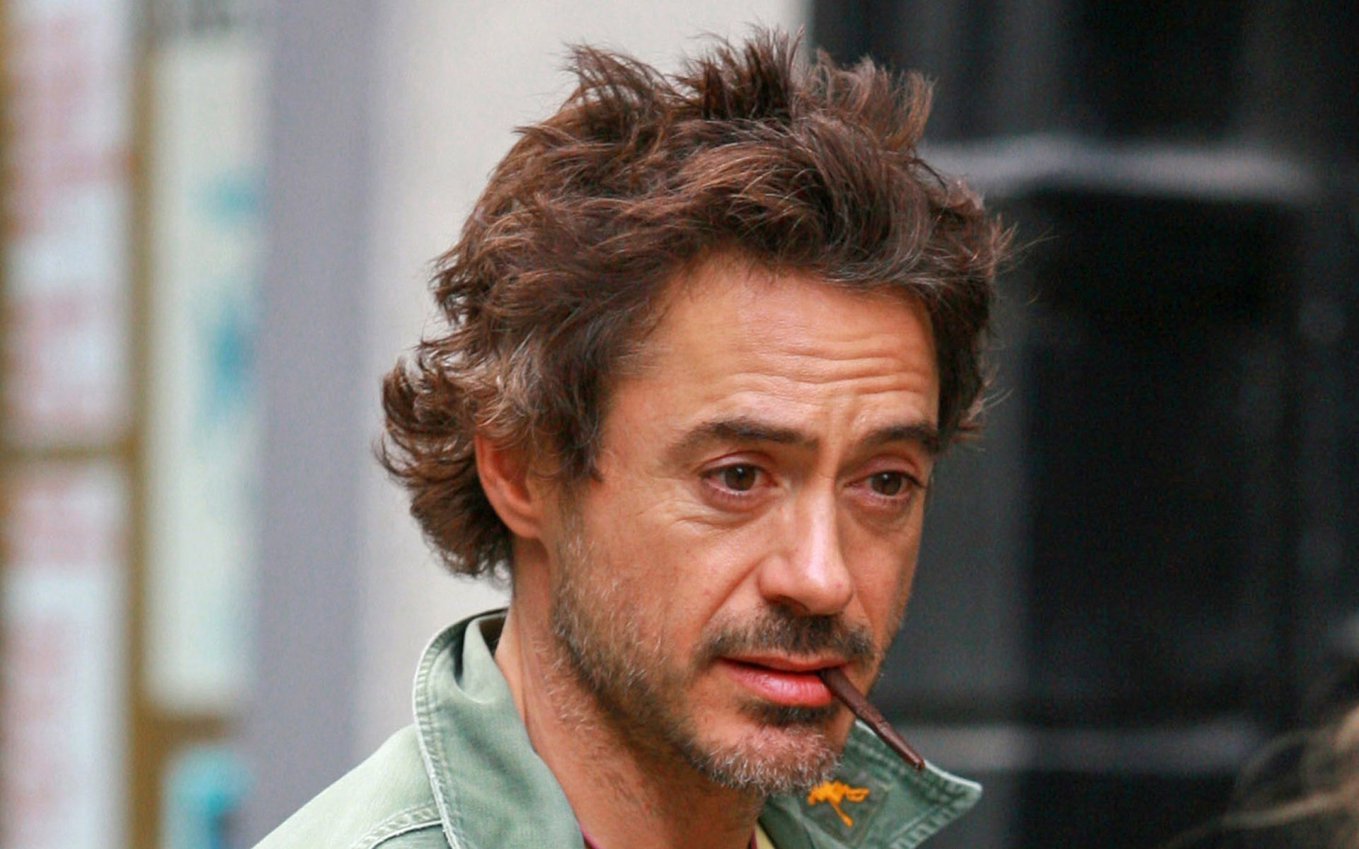 HD desktop wallpaper featuring American actor and celebrity Robert Downey Jr. with a casual, slightly tousled hairstyle and intense expression.