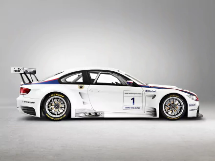 Side view of a white BMW M3 GT2 race car with sponsor decals and racing tires, shown as an HD PC desktop wallpaper and background.