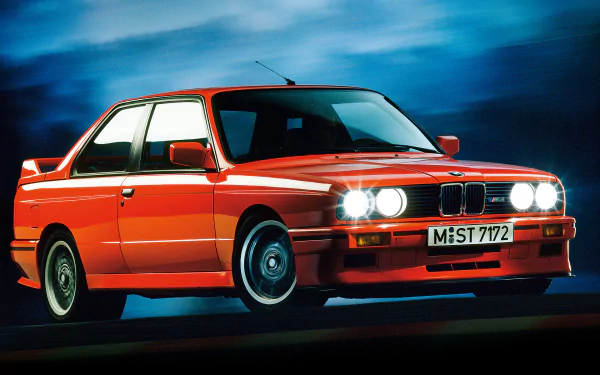 HD PC desktop wallpaper featuring a vibrant red BMW E30 M3 against a dramatic blue backdrop, showcasing the classic vehicle’s iconic design and headlights.