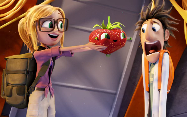 Sam Sparks joyfully presents a quirky animated strawberry to Flint Lockwood in a scene from Cloudy with a Chance of Meatballs 2, showcased as an HD desktop wallpaper.