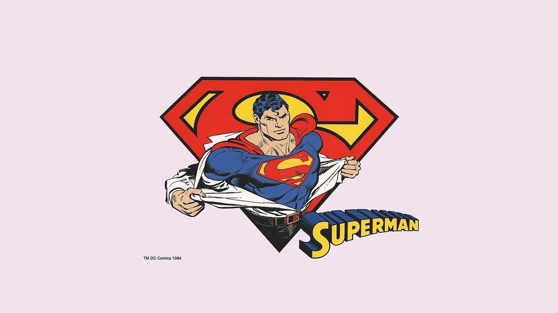 HD PC desktop wallpaper featuring classic comic-style Superman tearing open his shirt to reveal the iconic emblem against a light pink background.