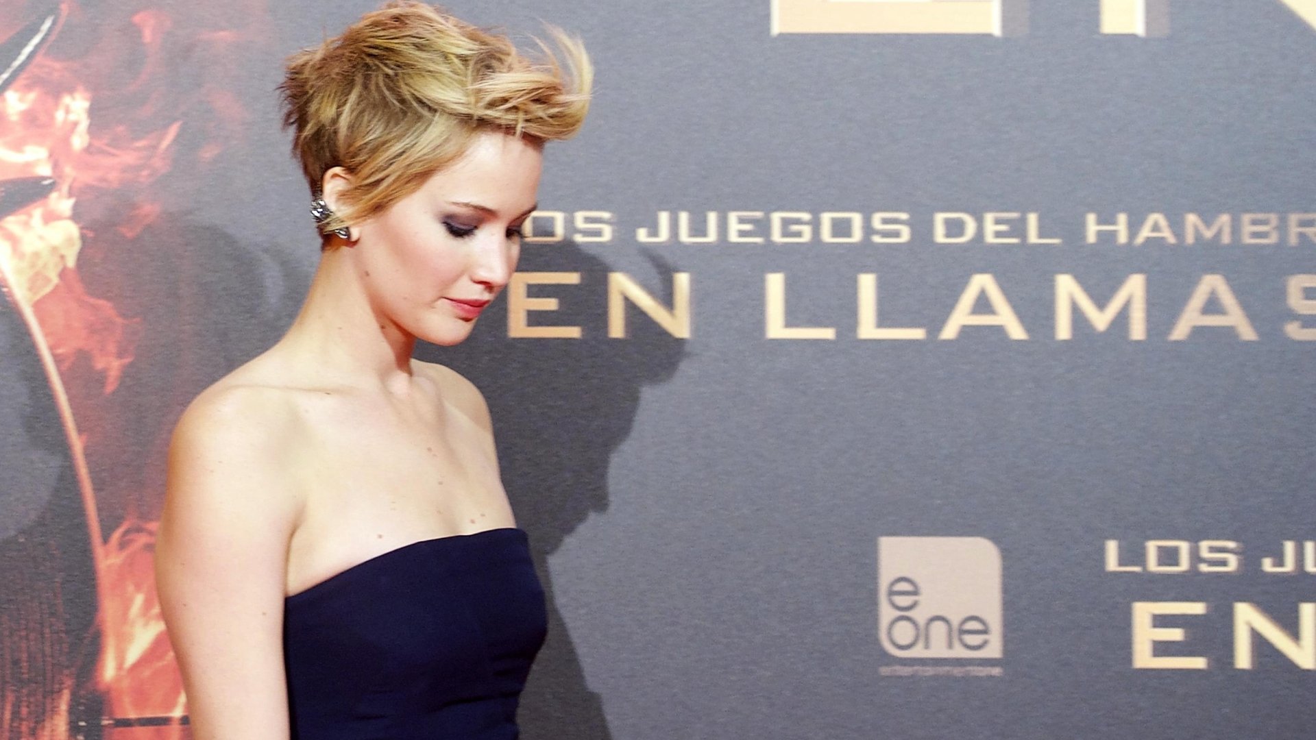 A captivating HD desktop wallpaper featuring Jennifer Lawrence, elegantly posed at a premiere event, exuding grace and style against a striking background.