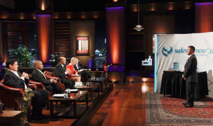 HD desktop wallpaper featuring a Shark Tank scene with investors evaluating a presenter.