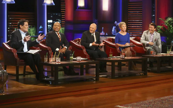 HD desktop wallpaper of the Shark Tank cast seated in the studio, engaging in discussion.