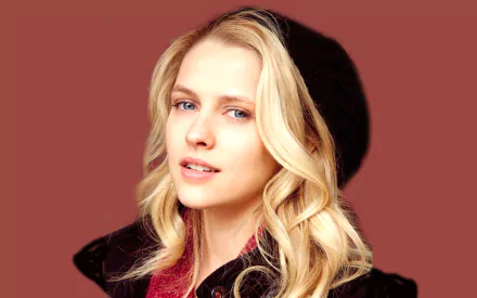 HD desktop wallpaper featuring Teresa Palmer, an Australian actress and celebrity, displaying her signature style with a warm expression against a rich background.