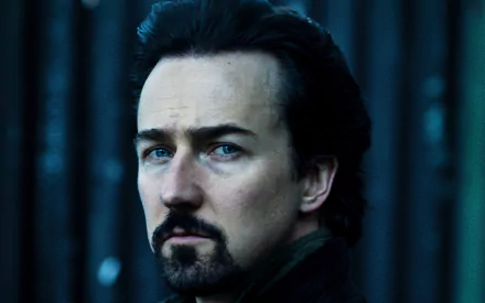 Close-up portrait of an American actor with dark hair, goatee and intense gaze in moody blue lighting — 2K Quad HD PC desktop wallpaper.