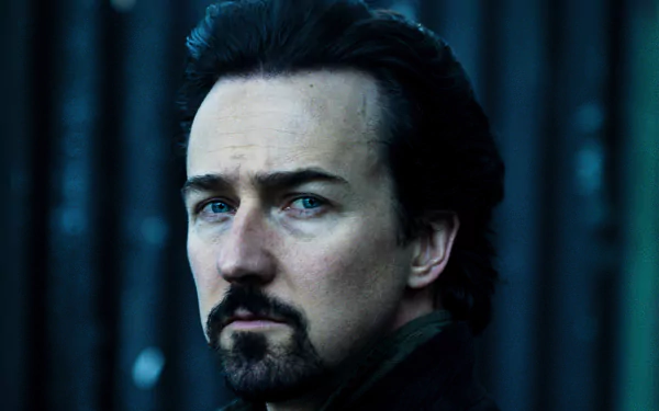 Close-up portrait of an American actor with dark hair, goatee and intense gaze in moody blue lighting — 2K Quad HD PC desktop wallpaper.