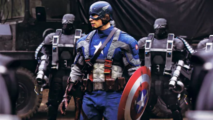 Captain America, portrayed by Chris Evans in Captain America: The First Avenger, stands resolute, shield in hand, flanked by menacing robotic soldiers in a dramatic HD wallpaper.