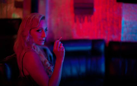 Kristin Scott Thomas in a moody, neon-lit scene from the movie Only God Forgives, featured as an HD PC desktop wallpaper and background.