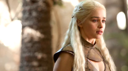 Emilia Clarke as Daenerys Targaryen in a captivating scene from the TV show Game of Thrones, showcasing her striking character against a natural backdrop.