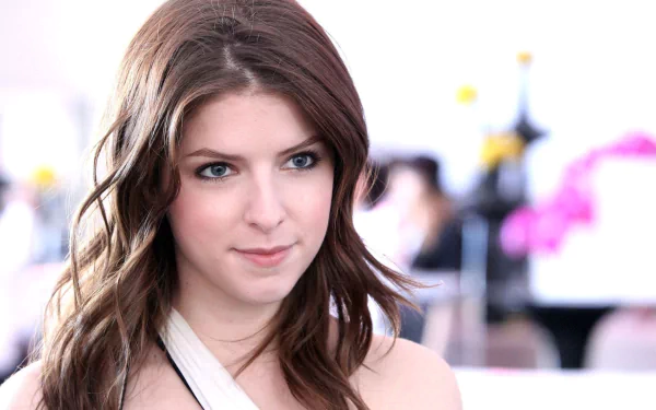 A close-up of American actress Anna Kendrick, featuring her with a thoughtful expression. The image serves as a stylish HD wallpaper or desktop background.
