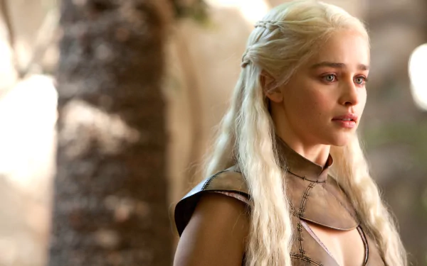 Emilia Clarke as Daenerys Targaryen in a captivating scene from the TV show Game of Thrones, showcasing her striking character against a natural backdrop.