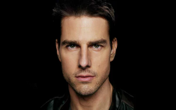 HD PC desktop wallpaper featuring a close-up portrait of celebrity Tom Cruise against a dark background.