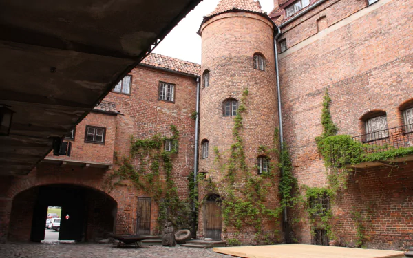 Ketrzyn Castle in Warmian‑Masurian, Poland — man-made brick building and European medieval architecture with ivy-clad towers and courtyard; HD PC desktop wallpaper background.