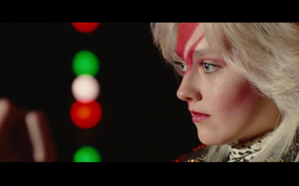 HD PC desktop wallpaper featuring Dakota Fanning as Joan Jett from the movie The Runaways, with distinctive lightning bolt face makeup and intense side profile.