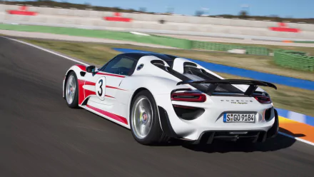 Rear three-quarter view of a white Porsche 918 Spyder race-liveried vehicle on a racetrack — HD PC desktop wallpaper and background.