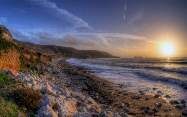 Sunset over the rocky coastline near the man-made Fort Clonque, captured in this HD PC desktop wallpaper and background.