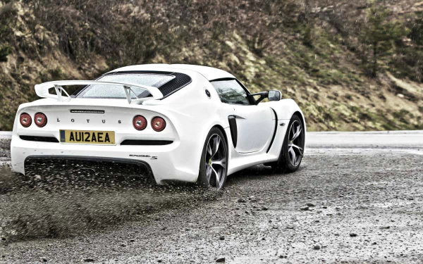 White Lotus Exige sports car parked on a gravel road, showcased as an HD PC desktop wallpaper and background.