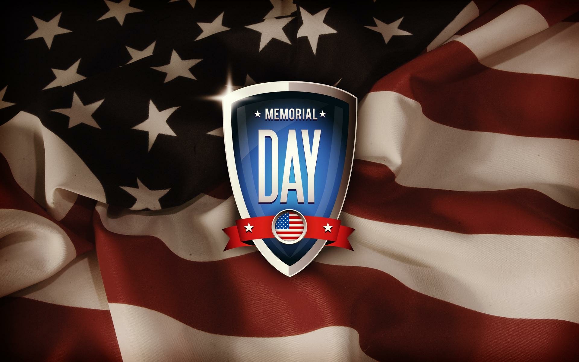 HD PC desktop wallpaper featuring a Memorial Day emblem against a softly folded American flag background, honoring the holiday.