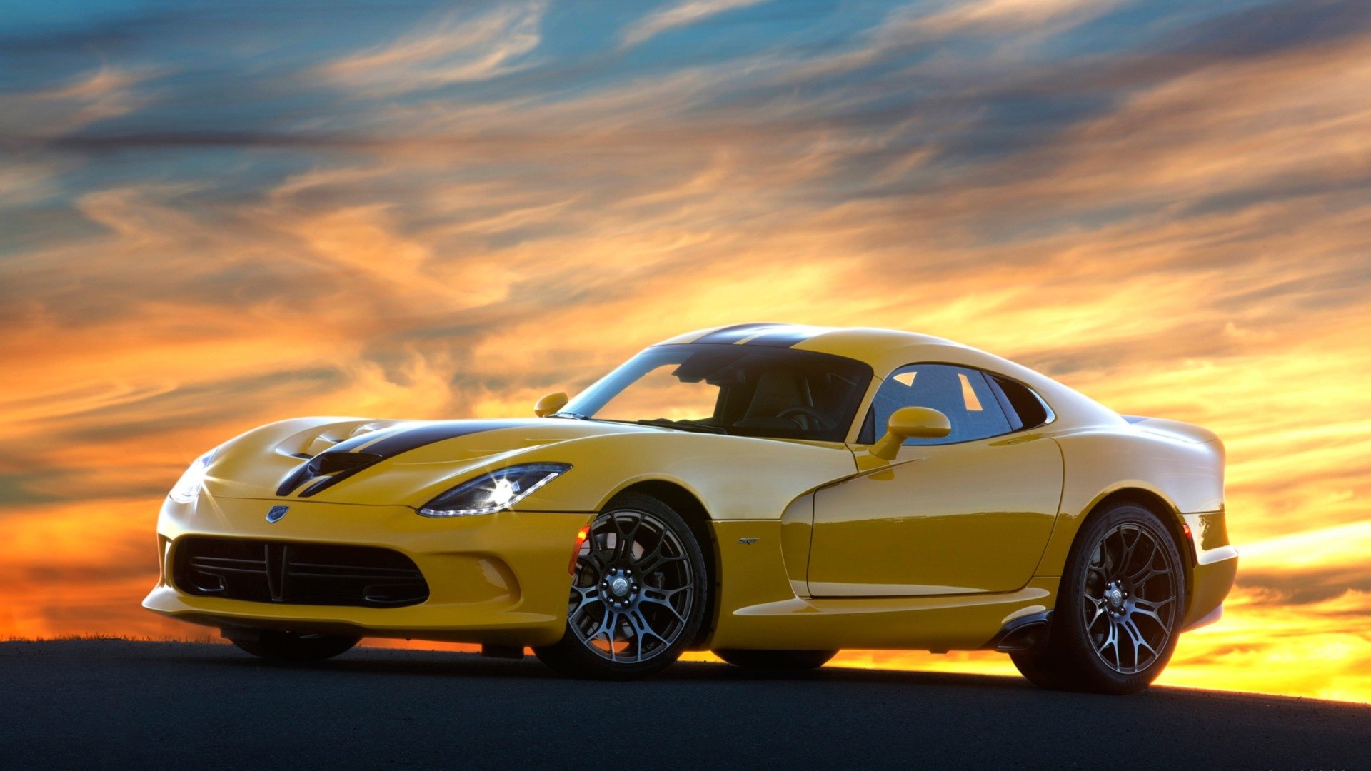 Yellow Dodge SRT Viper TA sports car on asphalt against a dramatic sunset sky - HD PC desktop wallpaper/background