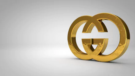A golden Gucci logo set against a sleek gray background, designed as an HD desktop wallpaper, showcasing a modern and luxurious aesthetic.