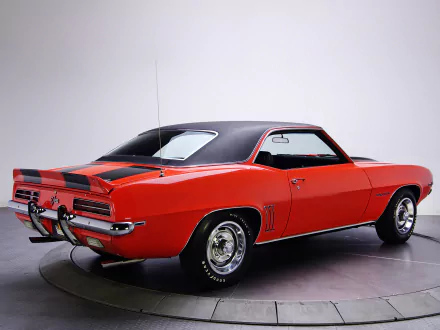 Red Chevrolet Camaro Z28 RS rear three-quarter studio shot with black vinyl roof and racing stripes — HD PC desktop wallpaper background