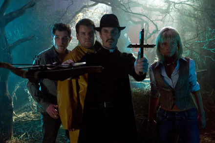 HD PC wallpaper: movie scene Lesbian Vampire Killers — four armed figures in a misty forest, one holding a cross, creating a tense, gothic-horror atmosphere.