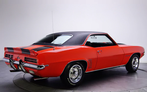 Red Chevrolet Camaro Z28 RS rear three-quarter studio shot with black vinyl roof and racing stripes — HD PC desktop wallpaper background