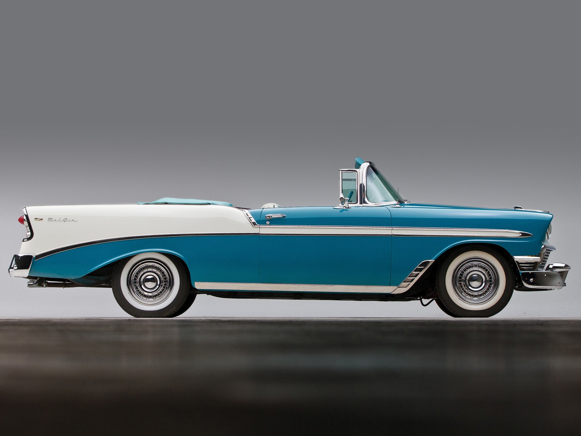 HD PC desktop wallpaper featuring a classic blue and white Chevrolet Bel Air convertible vehicle against a neutral gray background.